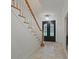 Foyer featuring tile flooring, staircase with decorative railing, and a frosted glass double front door at 885 Kelleytown Rd, Mcdonough, GA 30252
