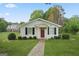 Charming white house with a red door and well-manicured lawn, offering classic curb appeal at 885 Kelleytown Rd, Mcdonough, GA 30252