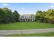 Charming exterior view of the property, featuring a sprawling lawn and mature trees at 885 Kelleytown Rd, Mcdonough, GA 30252