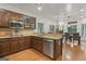 A well-equipped kitchen with wooden cabinets, granite countertops, and stainless steel appliances at 885 Kelleytown Rd, Mcdonough, GA 30252