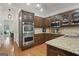This kitchen has dark cabinets, stainless steel appliances and granite countertops at 885 Kelleytown Rd, Mcdonough, GA 30252