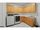 A functional laundry room featuring modern appliances, ample cabinet space, and a convenient sink at 885 Kelleytown Rd, Mcdonough, GA 30252