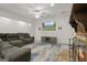 Open-concept living area with a stone fireplace, a television, and cozy seating on carpeted floors at 885 Kelleytown Rd, Mcdonough, GA 30252