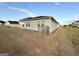 Spacious backyard with an air conditioning unit and views of surrounding neighborhood homes at 2051 Blue Sky Ave, Covington, GA 30016