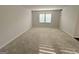 Large bedroom featuring neutral walls, carpet, and a window with natural light at 2051 Blue Sky Ave, Covington, GA 30016