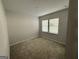 Bedroom with neutral walls, carpeted floor, and a window with blinds at 2051 Blue Sky Ave, Covington, GA 30016