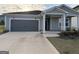 Charming home with gray siding, a two-car garage, and a well-maintained front yard at 2051 Blue Sky Ave, Covington, GA 30016