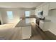 Modern kitchen with white cabinets, granite countertops, and stainless steel appliances at 2051 Blue Sky Ave, Covington, GA 30016