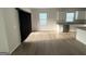 Open concept kitchen with stainless steel appliances, white cabinets, and wood flooring at 2051 Blue Sky Ave, Covington, GA 30016