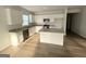 Bright kitchen with granite countertops, white cabinets, stainless steel appliances, and wood flooring at 2051 Blue Sky Ave, Covington, GA 30016