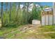 Spacious backyard featuring a storage shed and lush greenery at 1010 Capella Creek Way, Grayson, GA 30017