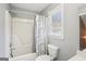 Cozy bathroom features a shower-tub combo, toilet, and window, creating a functional and comfortable space at 1010 Capella Creek Way, Grayson, GA 30017