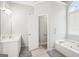 Bright bathroom featuring dual sinks and doorway to soaking tub and shower at 1010 Capella Creek Way, Grayson, GA 30017