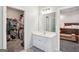 Bathroom vanity with white cabinets, a closet, and a doorway to the bedroom at 1010 Capella Creek Way, Grayson, GA 30017