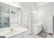 Bright bathroom featuring dual vanities, a soaking tub, and glass enclosed shower at 1010 Capella Creek Way, Grayson, GA 30017