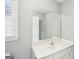 Bright bathroom featuring a large vanity, expansive mirror, and modern fixtures for a clean, updated look at 1010 Capella Creek Way, Grayson, GA 30017