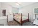 Bedroom with a four-poster bed, dresser, carpet floors, and natural light at 1010 Capella Creek Way, Grayson, GA 30017