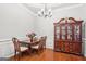 This formal dining room boasts a wooden table, stylish china cabinet, and elegant chandelier at 1010 Capella Creek Way, Grayson, GA 30017