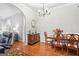 The formal dining room boasts elegant hardwood floors and a charming chandelier at 1010 Capella Creek Way, Grayson, GA 30017