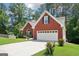 This lovely home features a two-car garage and is surrounded by mature trees and a manicured lawn at 1010 Capella Creek Way, Grayson, GA 30017