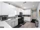 The kitchen features white cabinets, stainless steel appliances, and stylish countertops at 1010 Capella Creek Way, Grayson, GA 30017