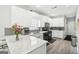 This kitchen has quartz countertops, white cabinets and black appliances at 1010 Capella Creek Way, Grayson, GA 30017