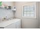 Functional laundry room with washer, dryer, and storage shelving, providing convenience and organization at 1010 Capella Creek Way, Grayson, GA 30017