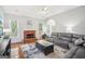 Cozy living room featuring hardwood floors, a brick fireplace, and a comfortable sectional sofa at 1010 Capella Creek Way, Grayson, GA 30017
