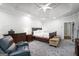 Spacious main bedroom features a tray ceiling, a ceiling fan, and a carpeted floor at 1010 Capella Creek Way, Grayson, GA 30017