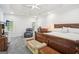 Spacious main bedroom features a tray ceiling, a ceiling fan, and a carpeted floor at 1010 Capella Creek Way, Grayson, GA 30017