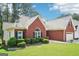A lovely view of the home's brick exterior and manicured landscaping, showcasing its charm and curb appeal at 1010 Capella Creek Way, Grayson, GA 30017