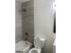 Modern bathroom with tiled shower over tub and white toilet at 103 Tiburon Ct, Stonecrest, GA 30038