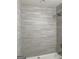 Close up on bathroom shower stall with gray and white tile surround and rainfall shower head at 103 Tiburon Ct, Stonecrest, GA 30038