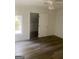 Bright bedroom features new flooring, a ceiling fan, and a door to another room at 103 Tiburon Ct, Stonecrest, GA 30038