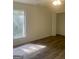 Bedroom featuring neutral walls, dark floors, a closet, and a window at 103 Tiburon Ct, Stonecrest, GA 30038