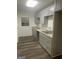 Modern kitchen features stylish cabinetry, granite countertops, and updated stainless sink at 103 Tiburon Ct, Stonecrest, GA 30038