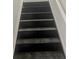 Close up of a wooden stairway with white trim at 103 Tiburon Ct, Stonecrest, GA 30038