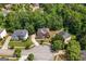 Aerial view of a neighborhood with mature trees surrounding single Gathering homes and cul-de-sac at 1429 Kentmire Court, Locust Grove, GA 30248