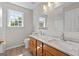 Bathroom features a double vanity and a large mirror with a window at 1429 Kentmire Court, Locust Grove, GA 30248