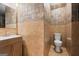 Bathroom featuring decorative tile on the walls, a sink, and a toilet at 1429 Kentmire Court, Locust Grove, GA 30248