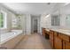 Bright bathroom features a soaking tub, glass-enclosed shower, and double sink vanity at 1429 Kentmire Court, Locust Grove, GA 30248