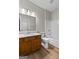 Bathroom featuring a wooden vanity with granite countertop and a white tiled shower and tub at 1429 Kentmire Court, Locust Grove, GA 30248