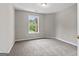 Bright bedroom features a large window and neutral carpet at 1429 Kentmire Court, Locust Grove, GA 30248