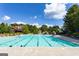 Large community pool with clear blue water, surrounded by lounge chairs and lush landscaping at 1429 Kentmire Court, Locust Grove, GA 30248