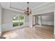 Bright dining room featuring large windows, molding details, and an open floor plan at 1429 Kentmire Court, Locust Grove, GA 30248
