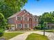 Beautiful two-story brick home with a manicured lawn and a circular driveway at 1429 Kentmire Court, Locust Grove, GA 30248