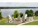 Lakeside fire pit with Adirondack chairs; an inviting outdoor gathering spot with scenic water views at 1429 Kentmire Court, Locust Grove, GA 30248