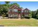 Stately two-story brick home with white trim, mature landscaping, and inviting curb appeal at 1429 Kentmire Court, Locust Grove, GA 30248