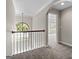 Hallway featuring an arched doorway, a chandelier and a window bringing in natural light at 1429 Kentmire Court, Locust Grove, GA 30248