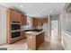 Spacious kitchen featuring stainless steel appliances, a center island, and great natural light at 1429 Kentmire Court, Locust Grove, GA 30248